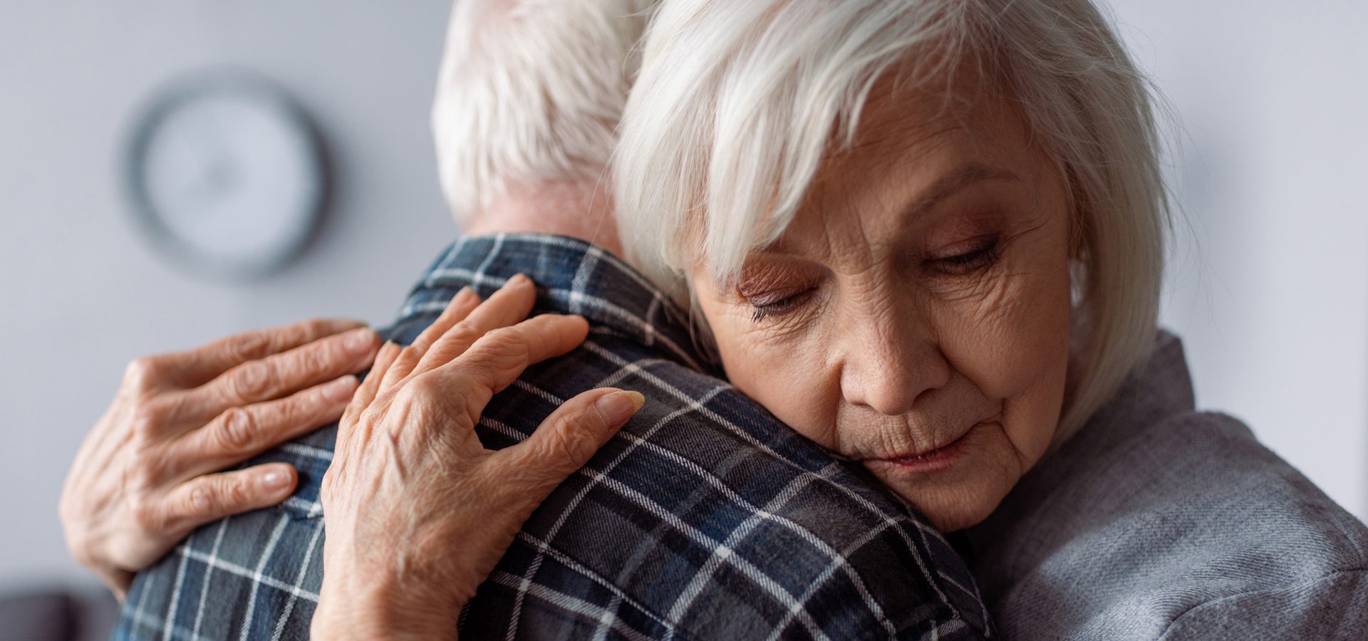 Two older people share an embrace